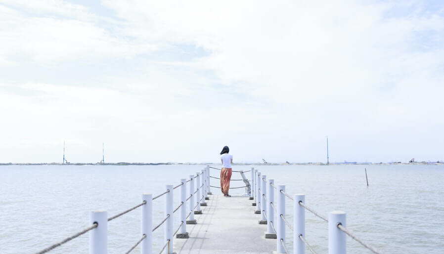 girl back view lonely on dock