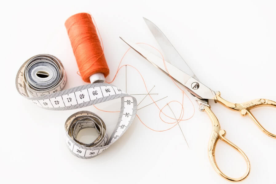 sewing kit thread, scissor, and tape measure