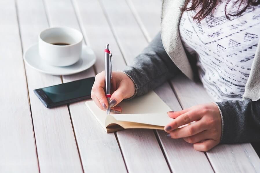 woman hand writing on a desk woman hand writing on a desk