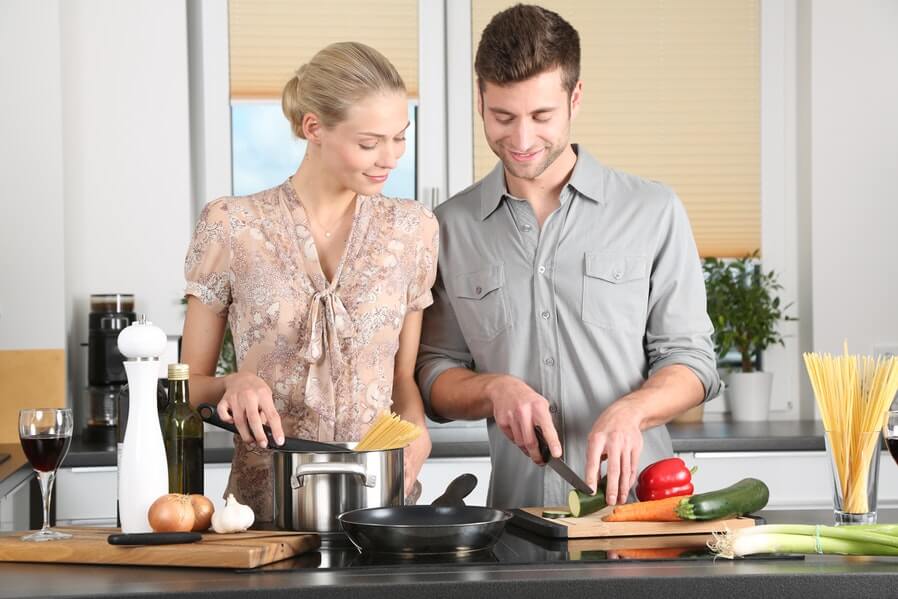 Husband and wife cooking for their meal Living together be mindful about division of chores
