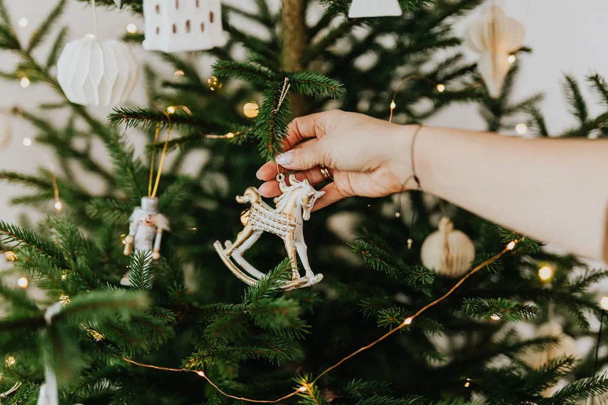 person holding rocking horse christmas ornament