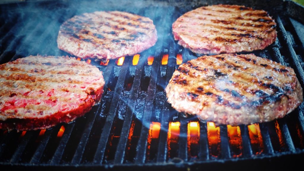 Burger patties getting grilled