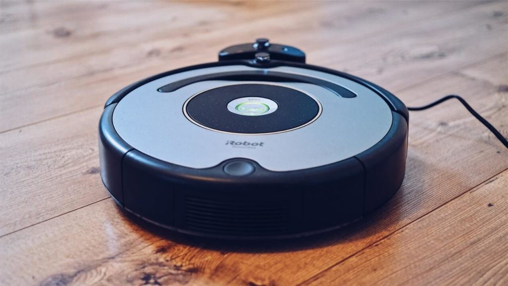 Cleaner robot standing on a wooden floor