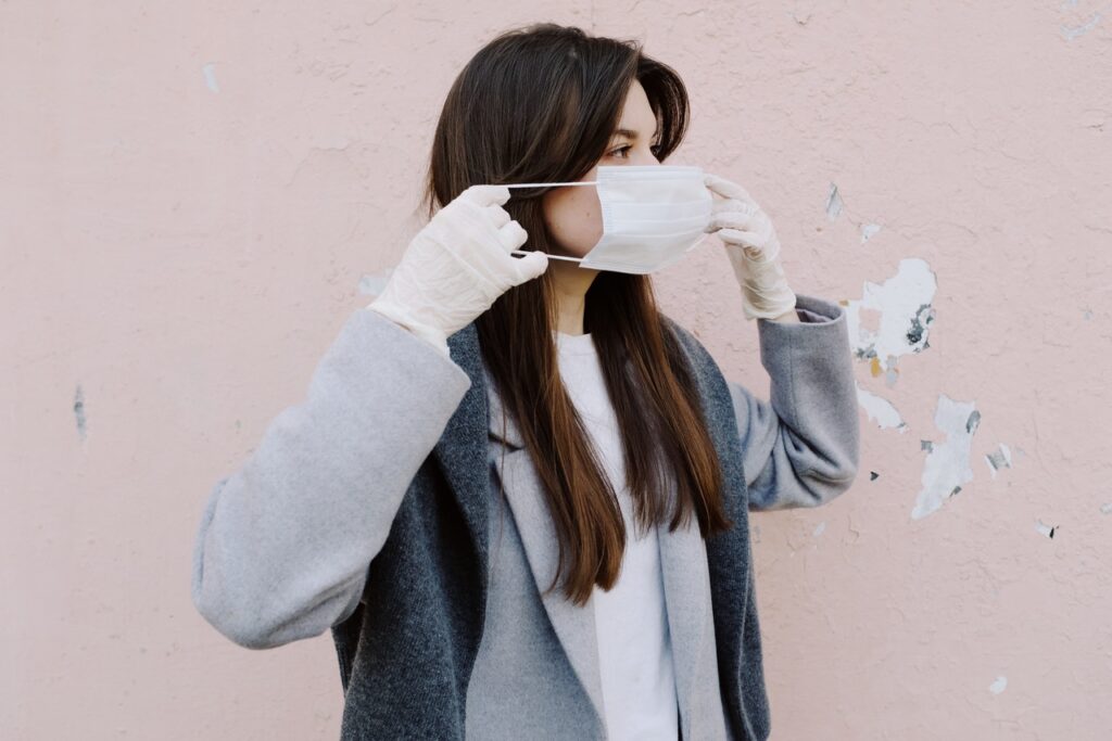 woman putting on a face mask