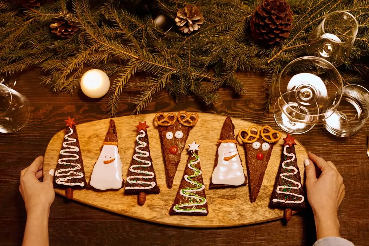 person serving a freshly baked brownies on a wooden tray