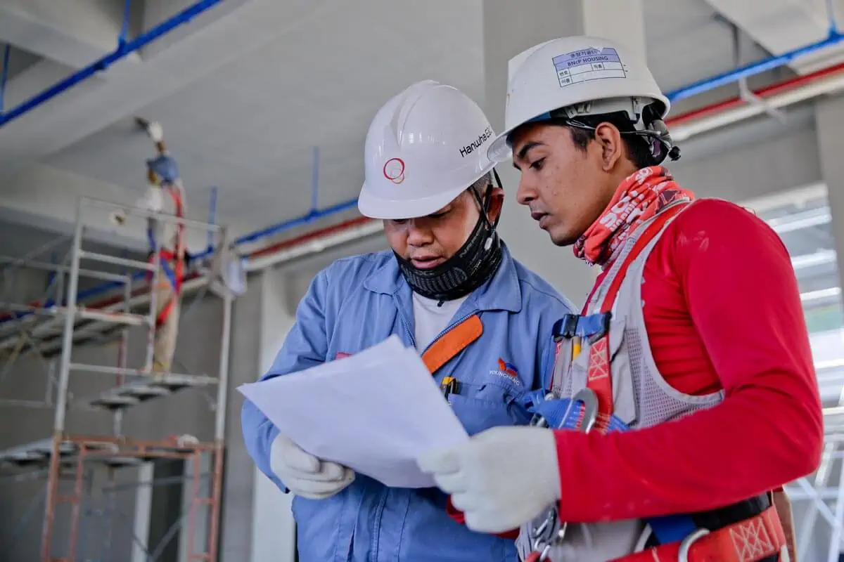 two construction worker looking at a plan