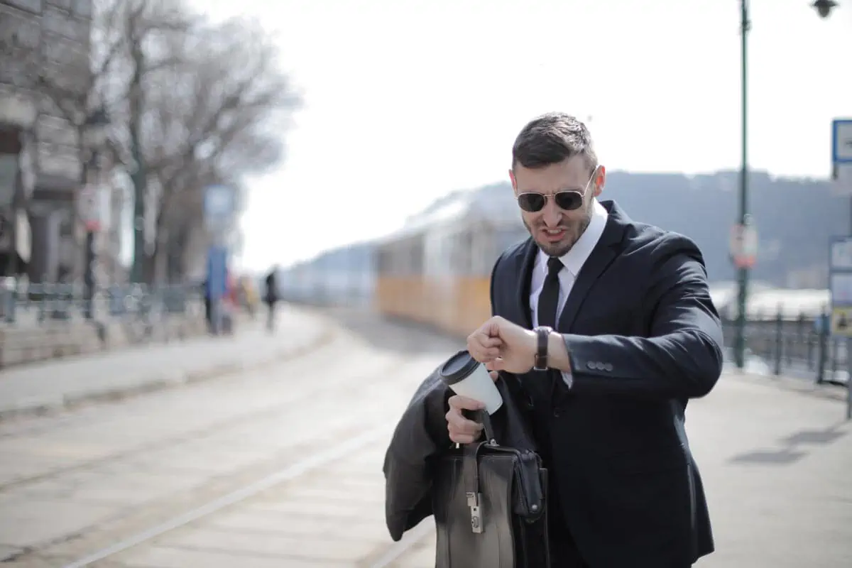 man on a suit looking at wrist clock
