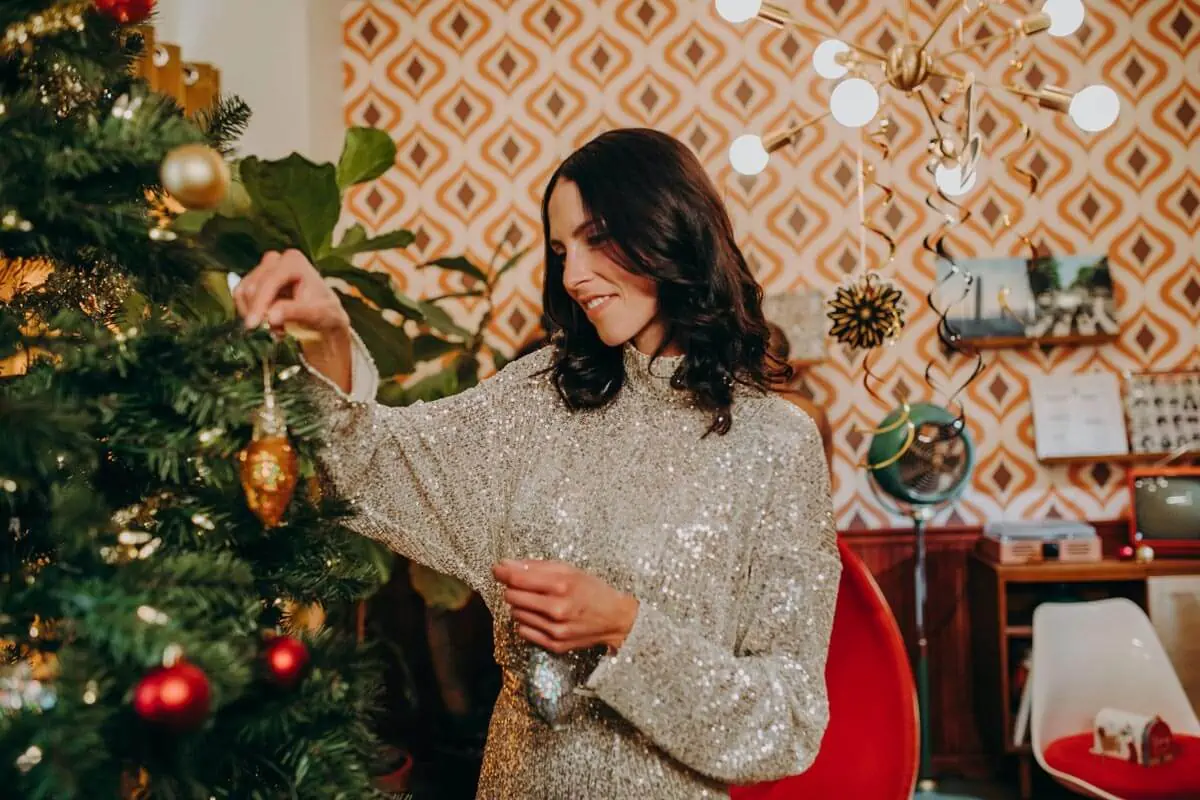 woman decorating christmas tree