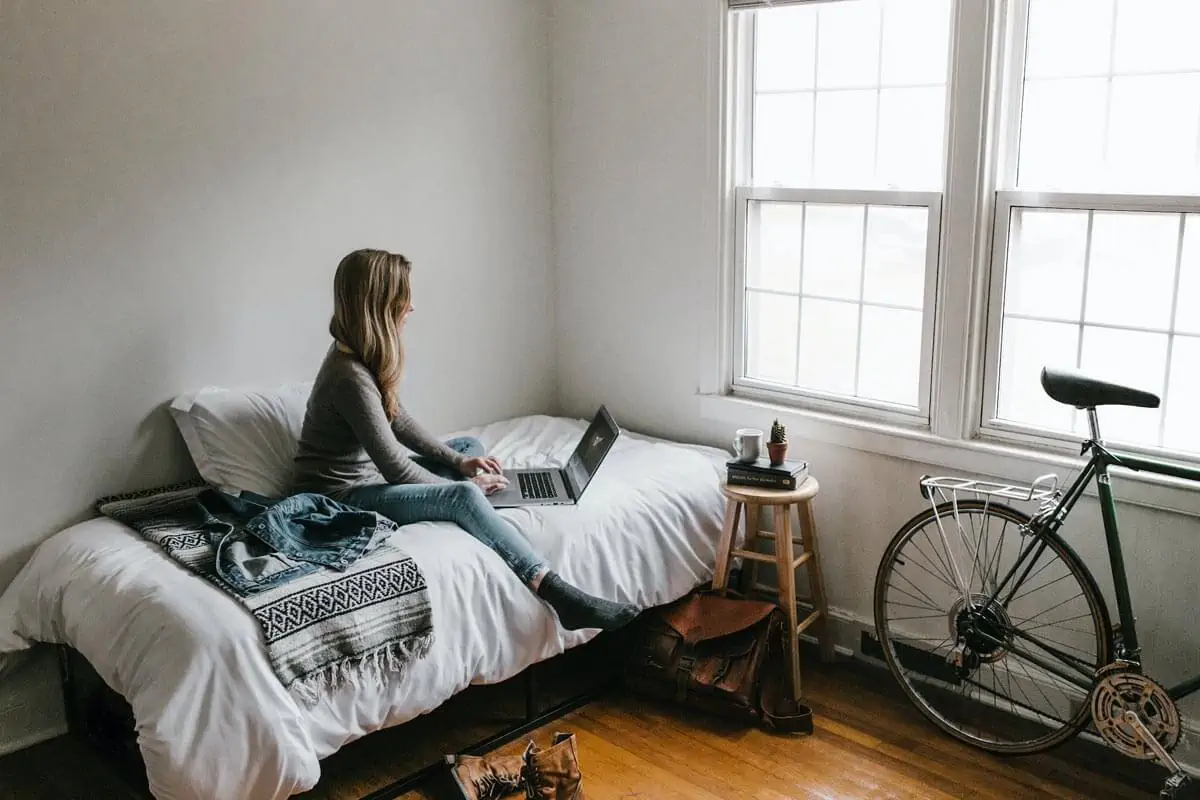 woman using laptopn on bed