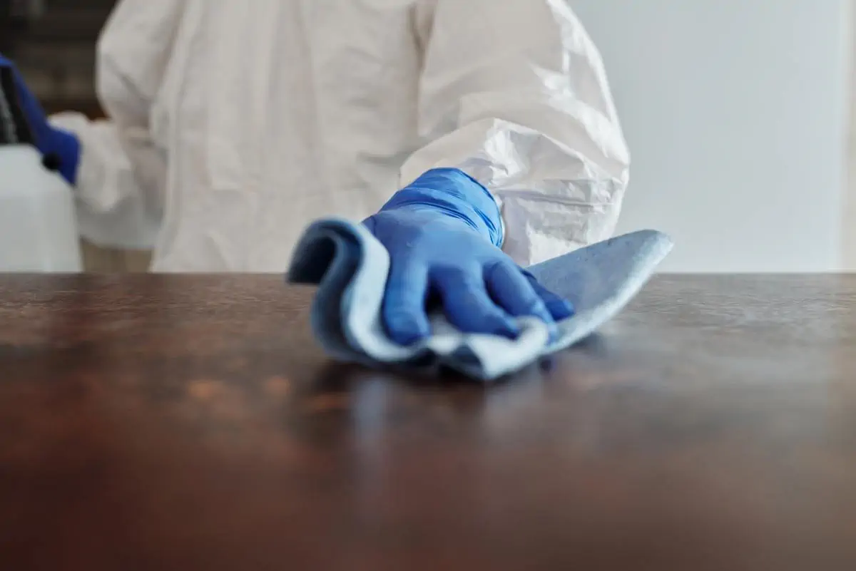 Cleaning table using gloves and cloth