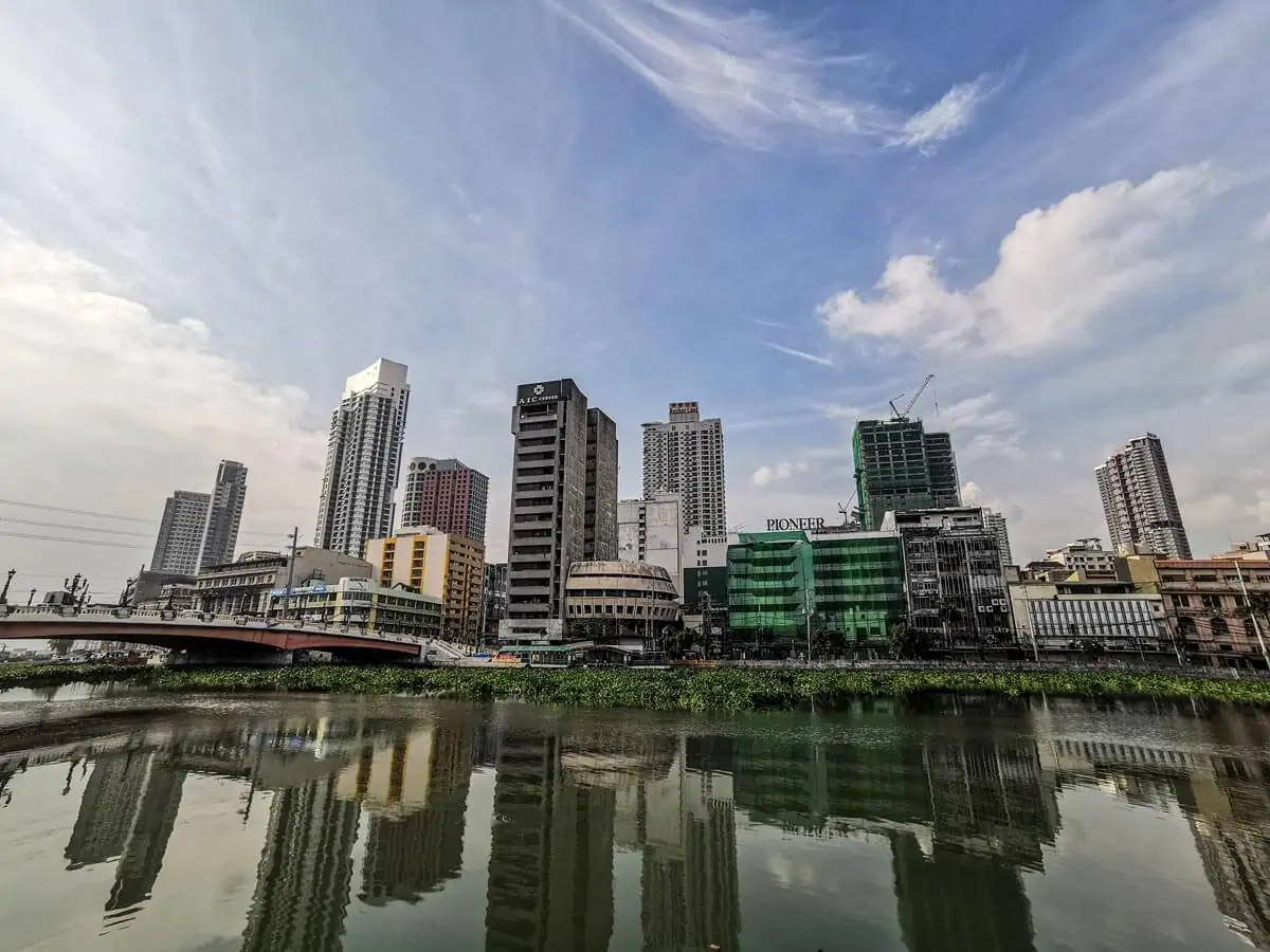 Modern city with tall buildings on river bay