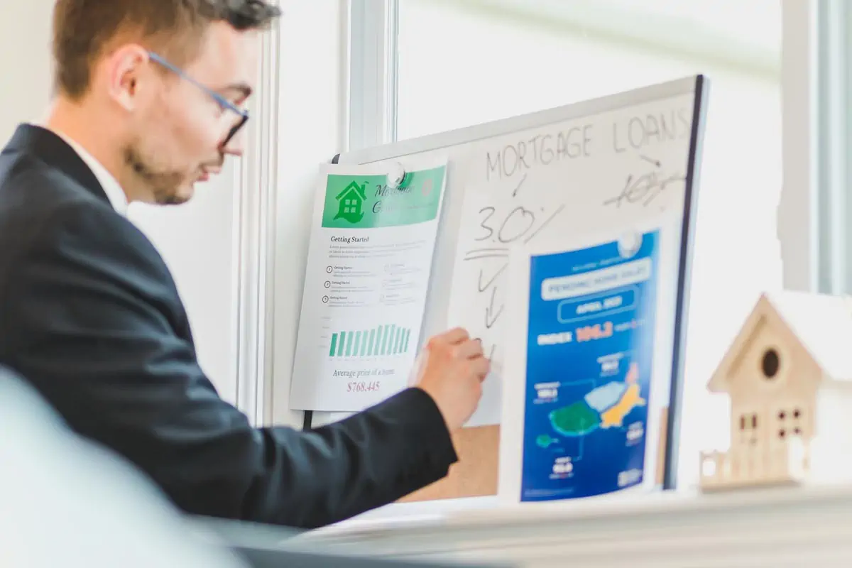 a man in a blacksuit working on mortgage calculation