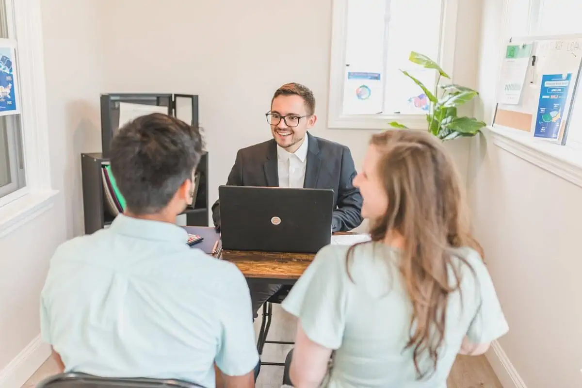 couple talking to professional infront of laptop