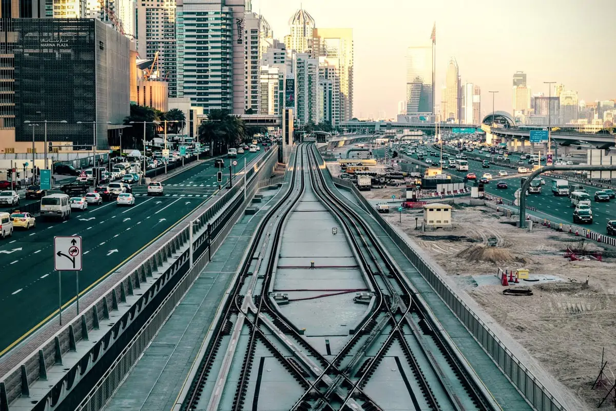 Tilt-shift Photography of Railway in Between of Roads at Day