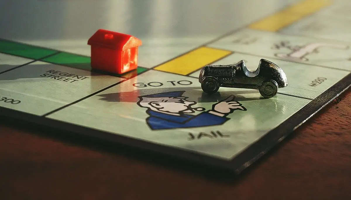 miniature toy car on monopoly board game