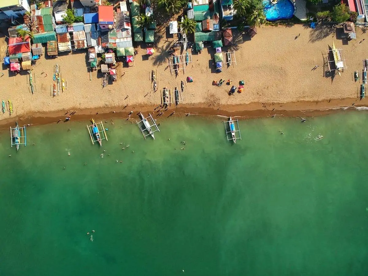 an aerial shot of a shore with docked boats