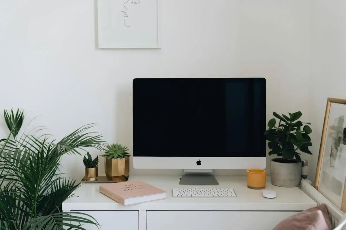 an imac cuter over a white desk