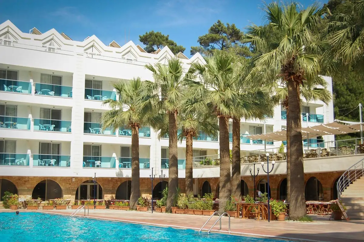 white 3 storey building surrounded with trees