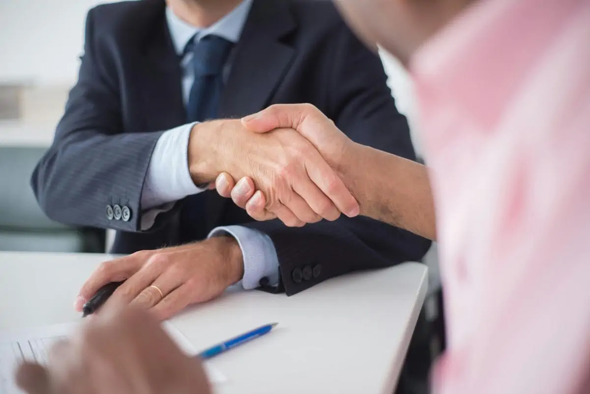 close up of shaking hands between men