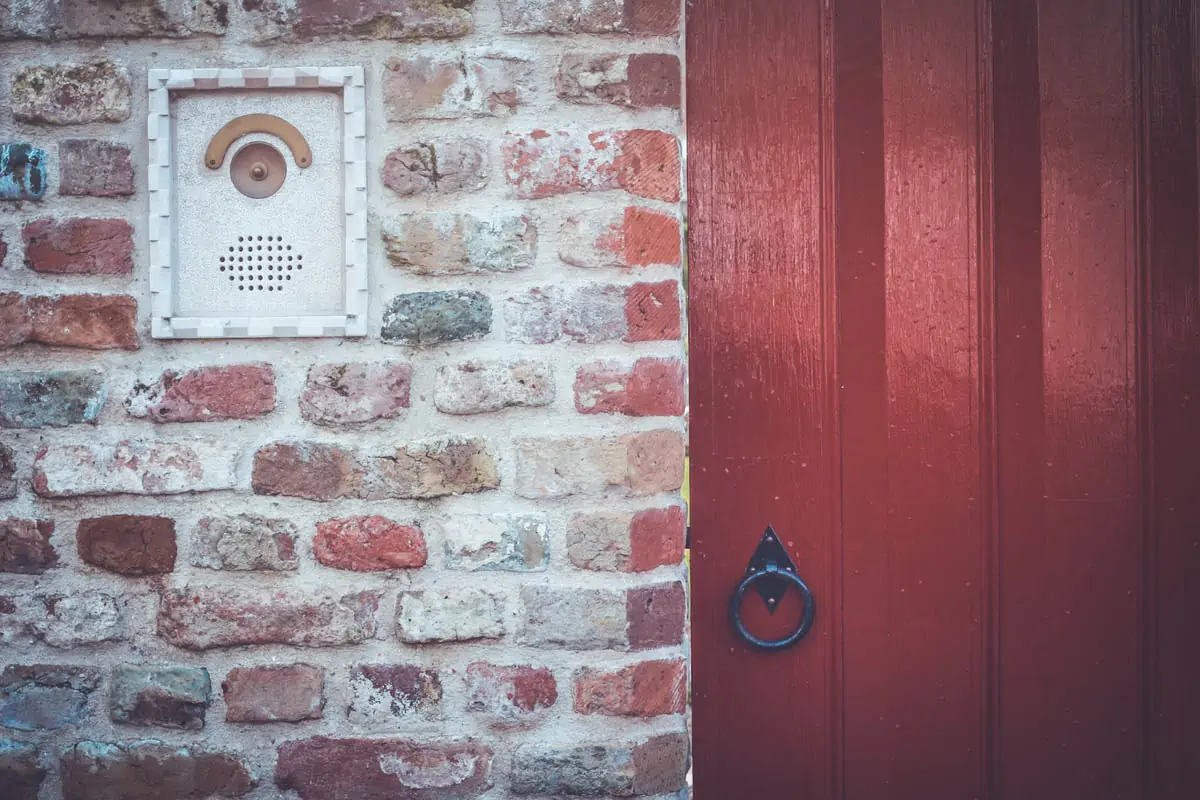 a-brick-wall-with-a-red-door