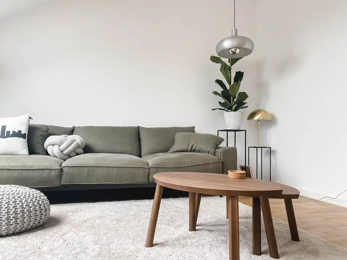 gray-2-seat-sofa-near-brown-wooden-coffee-table