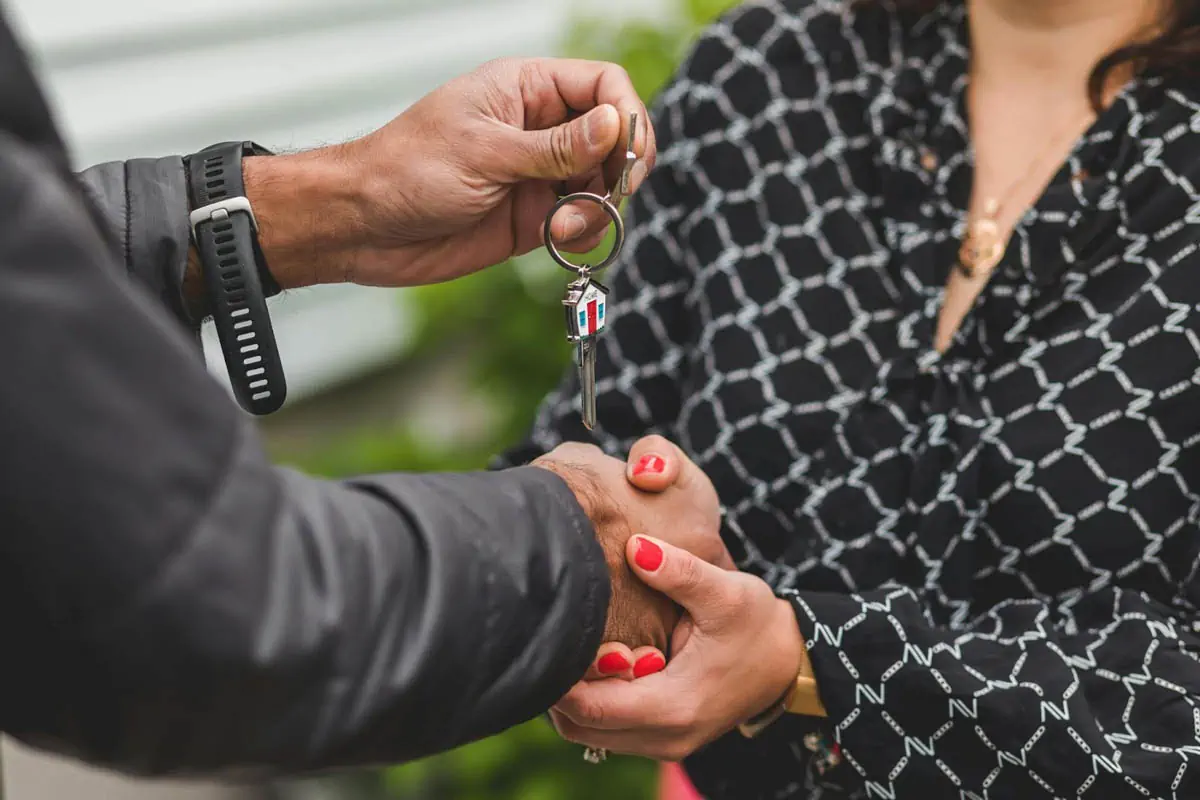 person-holding-a-silver-key