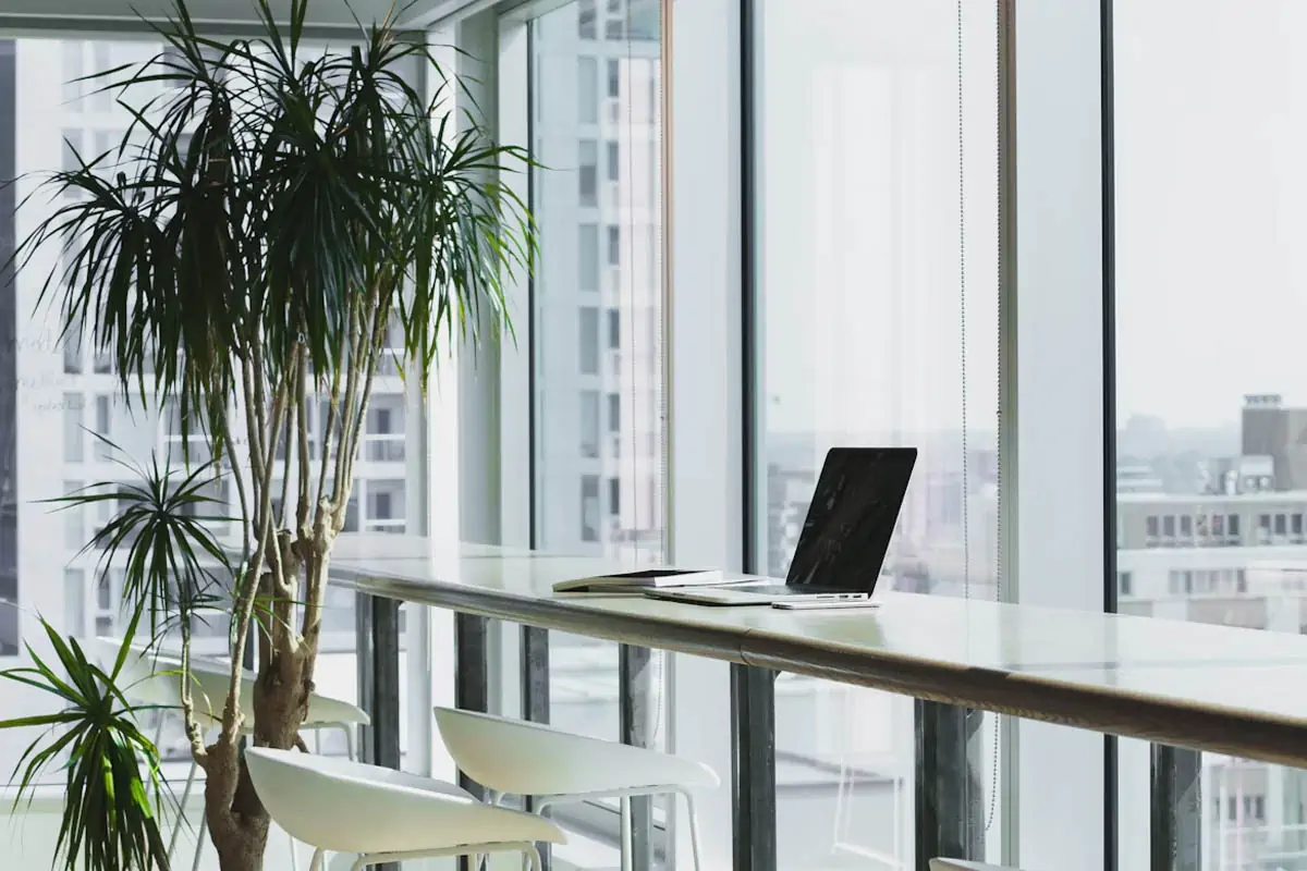 turned-off-laptop-computer-on-top-of-brown-wooden-table