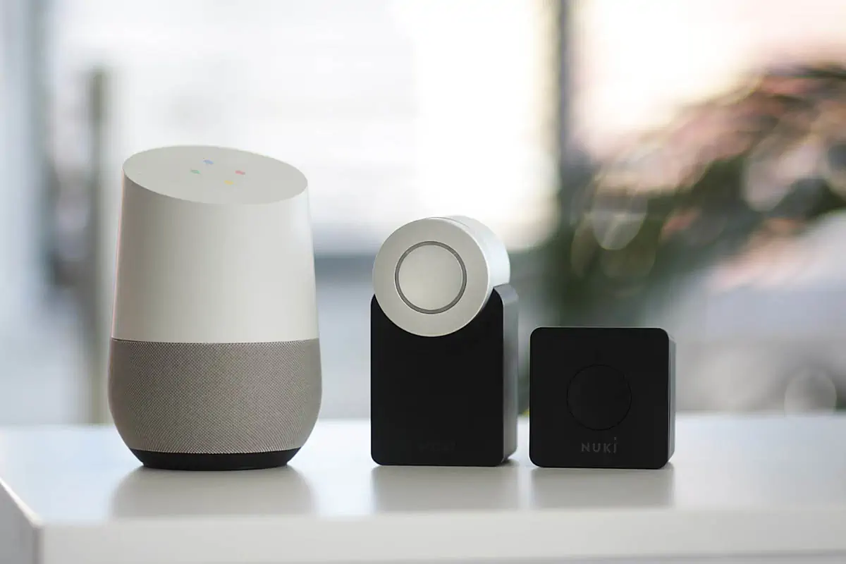 white-and-gray-google-smart-speaker-and-two-black-speakers