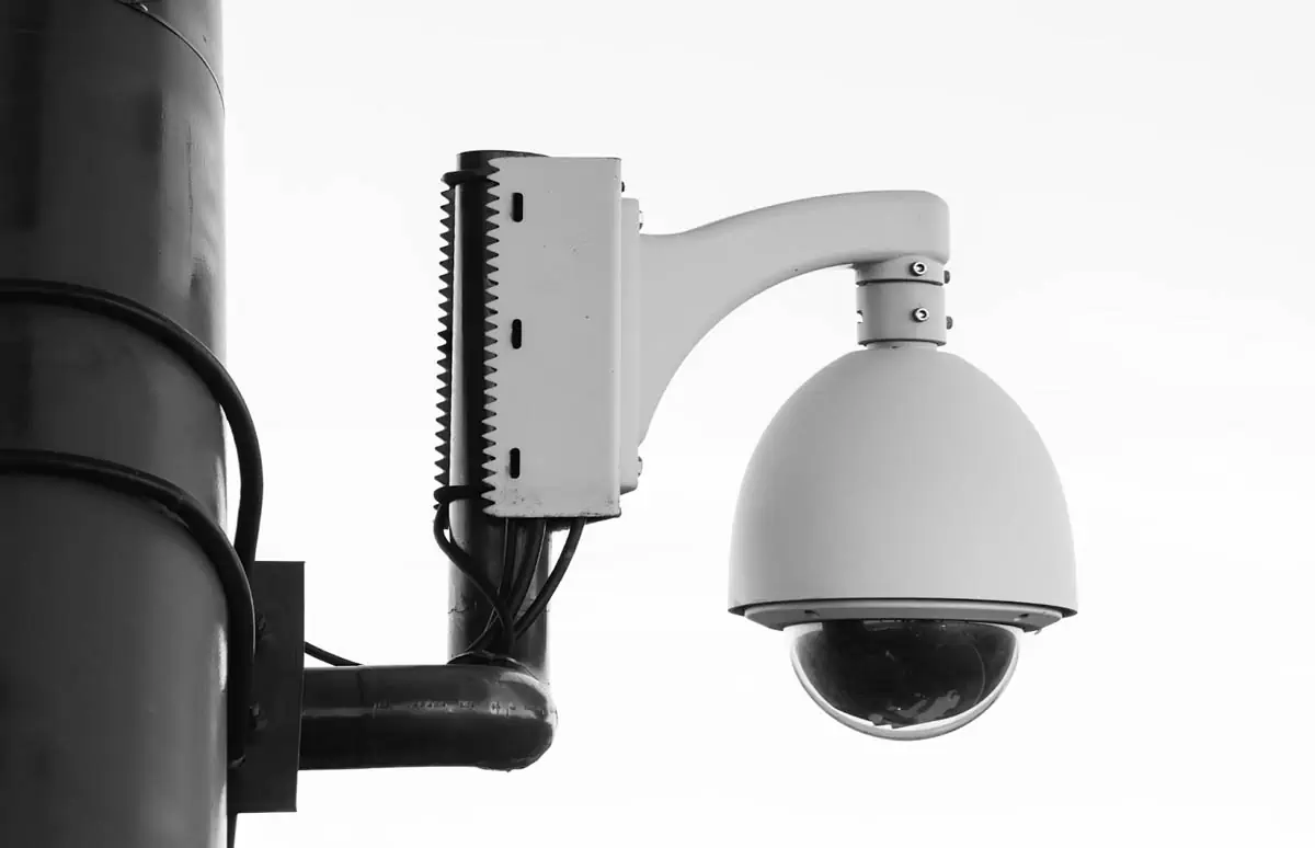 white-security-camera-on-post
